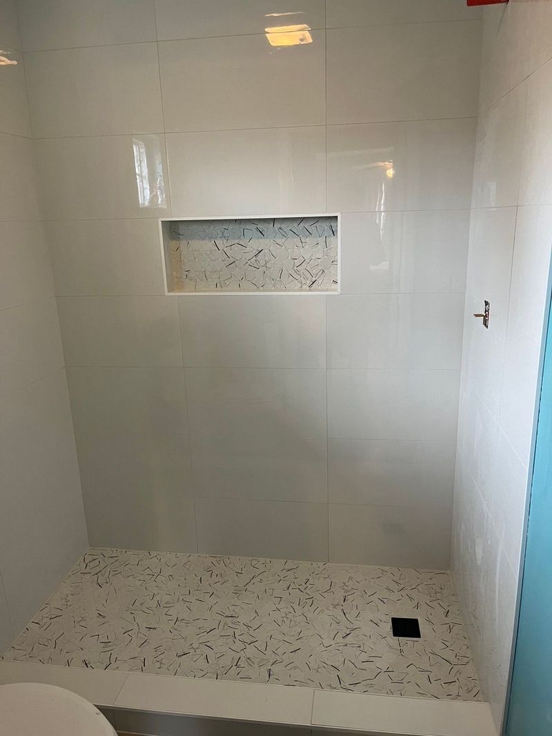 Large-format tile shower with niche